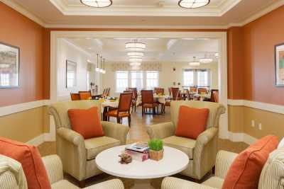 A cozy interior with comfortable seating and a dining area in the background.