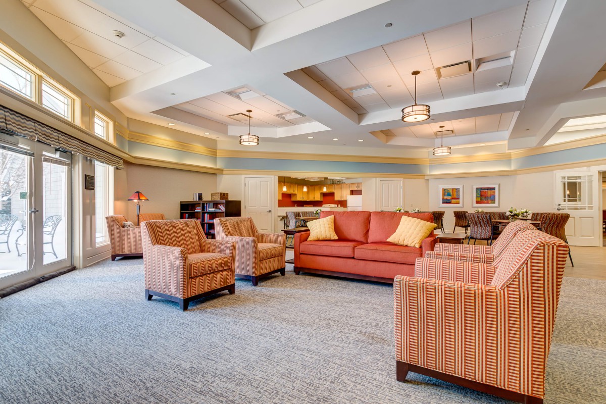 A modern lounge area featuring comfortable sofas and chairs with warm lighting.