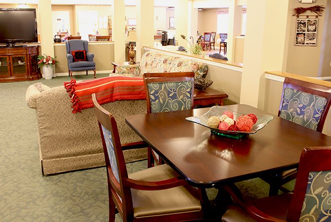 A cozy living room with a dining table and comfortable seating area.
