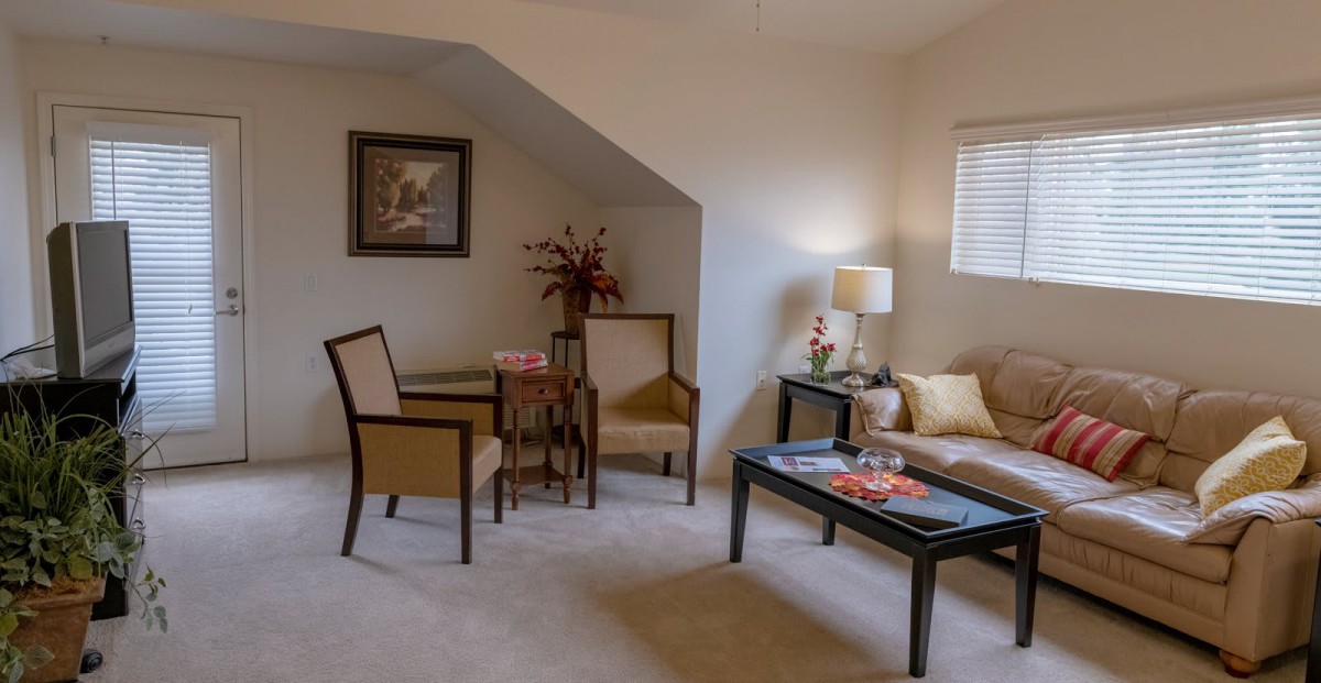 A cozy living room with elegant furniture and warm lighting.