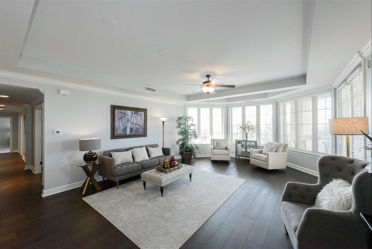 A modern living room with elegant furnishings and large windows.