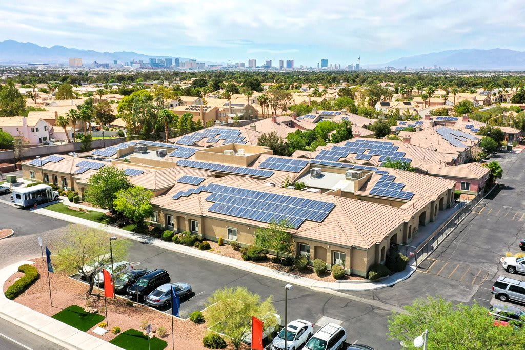 Aerial view of a suburban area with solar panels installed on the rooftops.