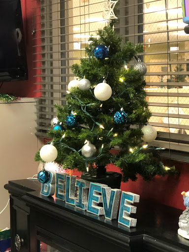 A beautifully decorated Christmas tree with blue and white ornaments, spreading holiday cheer.