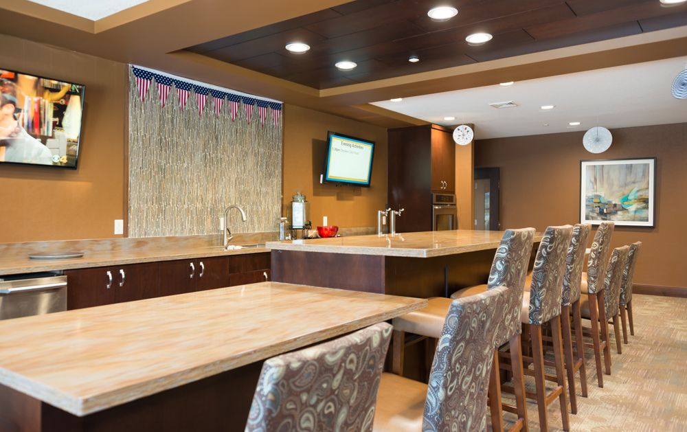 A modern bar interior with a sleek counter and stylish seating.