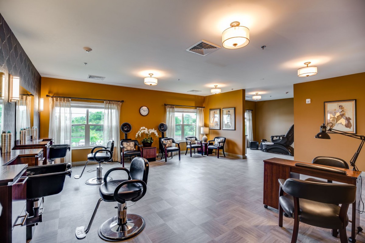 A spacious salon interior featuring styling chairs, mirrors, and a comfortable waiting area.