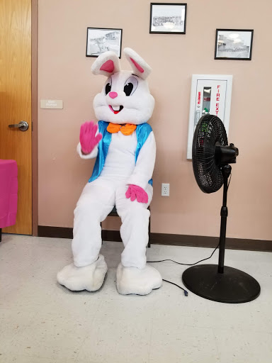 A cheerful bunny mascot waving in a playful pose.
