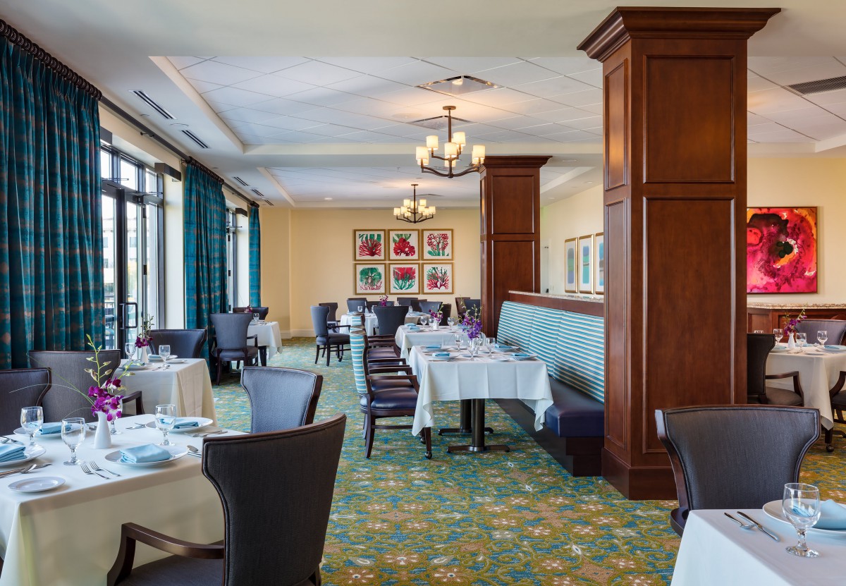 A well-decorated restaurant dining area with neatly arranged tables and chairs.