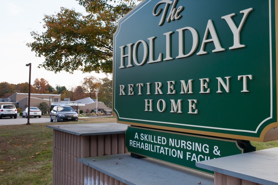 Sign for The Holiday Retirement Home, a skilled nursing and rehabilitation facility.