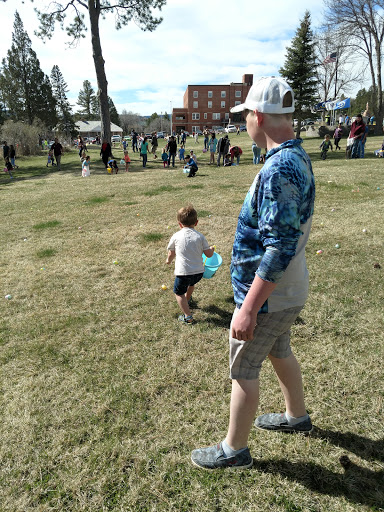 A sunny day at the park, with children enjoying a playful outdoor activity.
