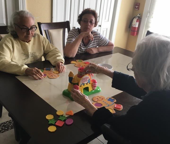 A group of people gathered around a table, enjoying a game together.