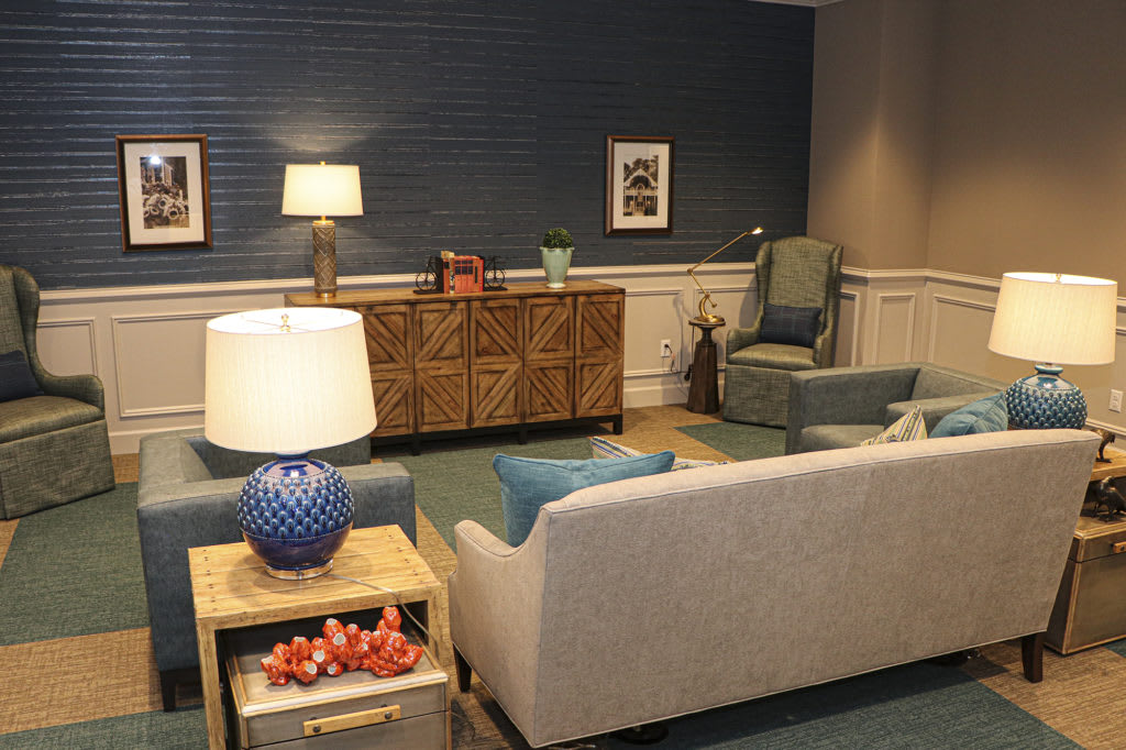 A cozy living room with a sofa, lamps, and stylish decor.