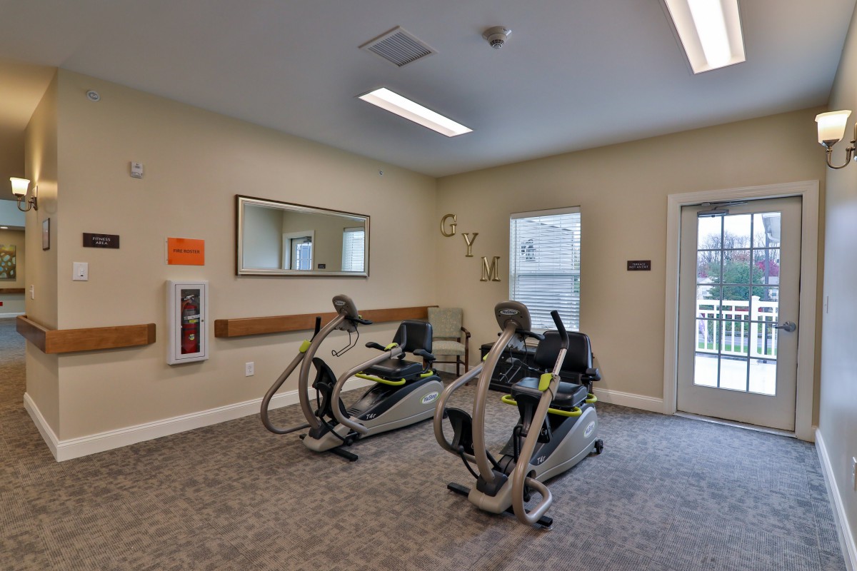 A small fitness room with exercise machines for cardio workouts.