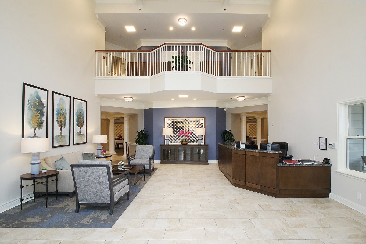 Modern hotel lobby with a reception desk and comfortable seating area.
