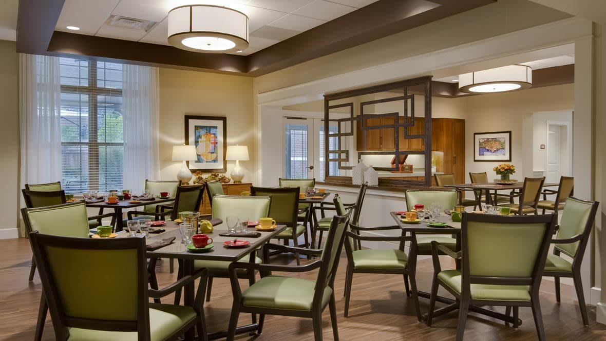 An elegantly decorated dining room with neatly arranged tables and chairs.