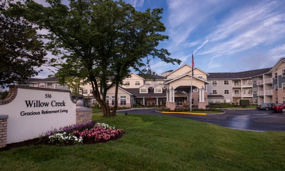 A hotel exterior with manicured landscaping and a welcoming entrance.