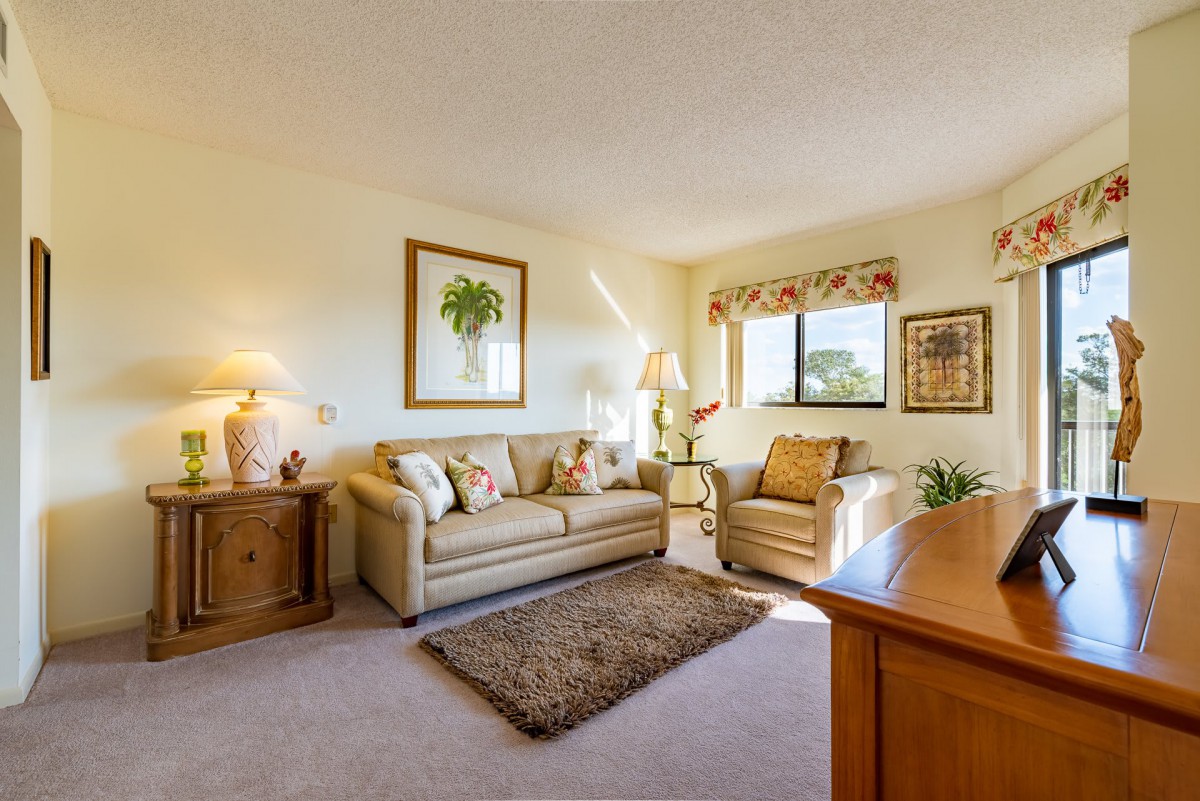 A cozy living room with comfortable seating, warm lighting, and tasteful decorations.