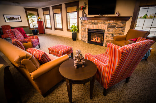 A cozy living room with comfortable seating and a fireplace.