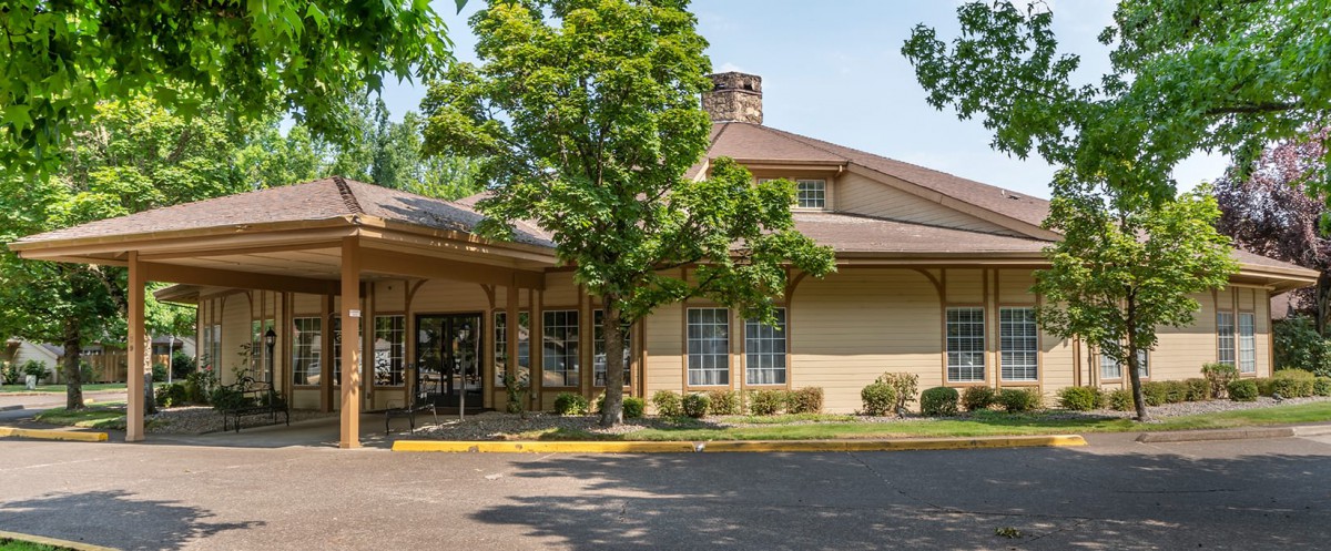A view of a building's exterior featuring trees and an entrance.