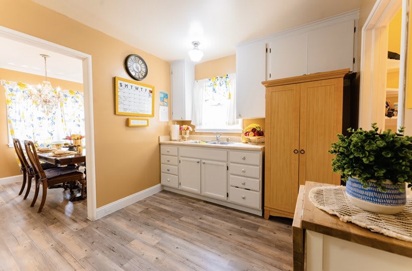 A modern kitchen with wooden cabinets and bright lighting.
