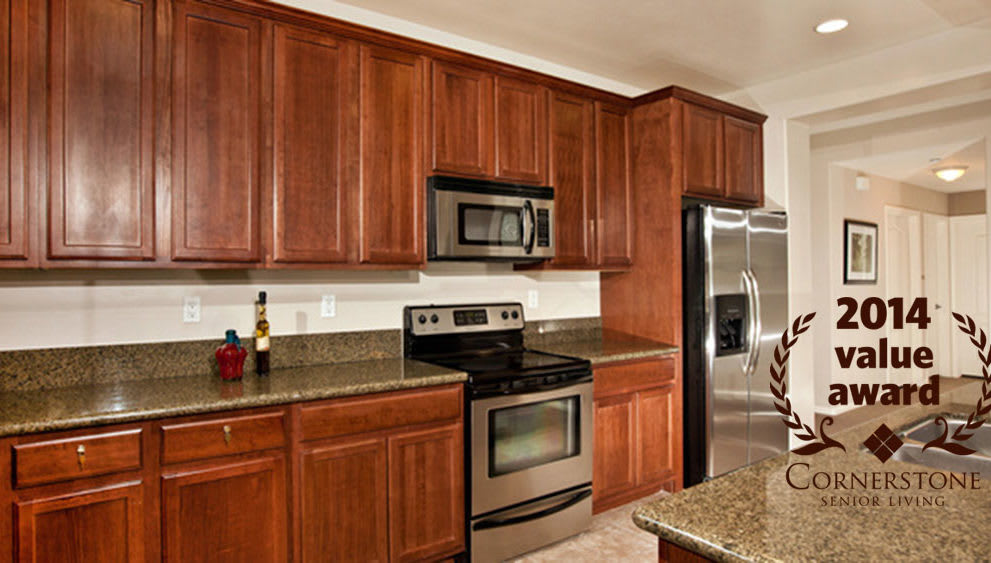 Modern kitchen with wood cabinets and stainless steel appliances.