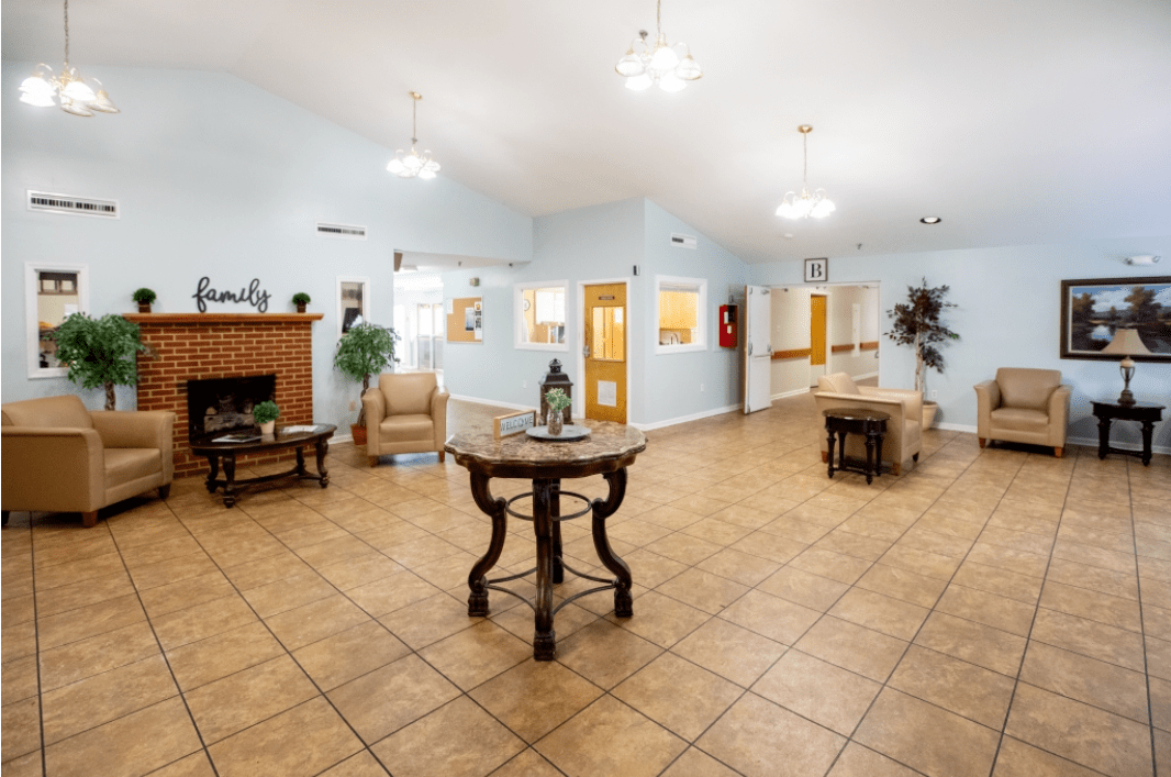 A spacious and bright lobby area with tiled floors and elegant furniture.
