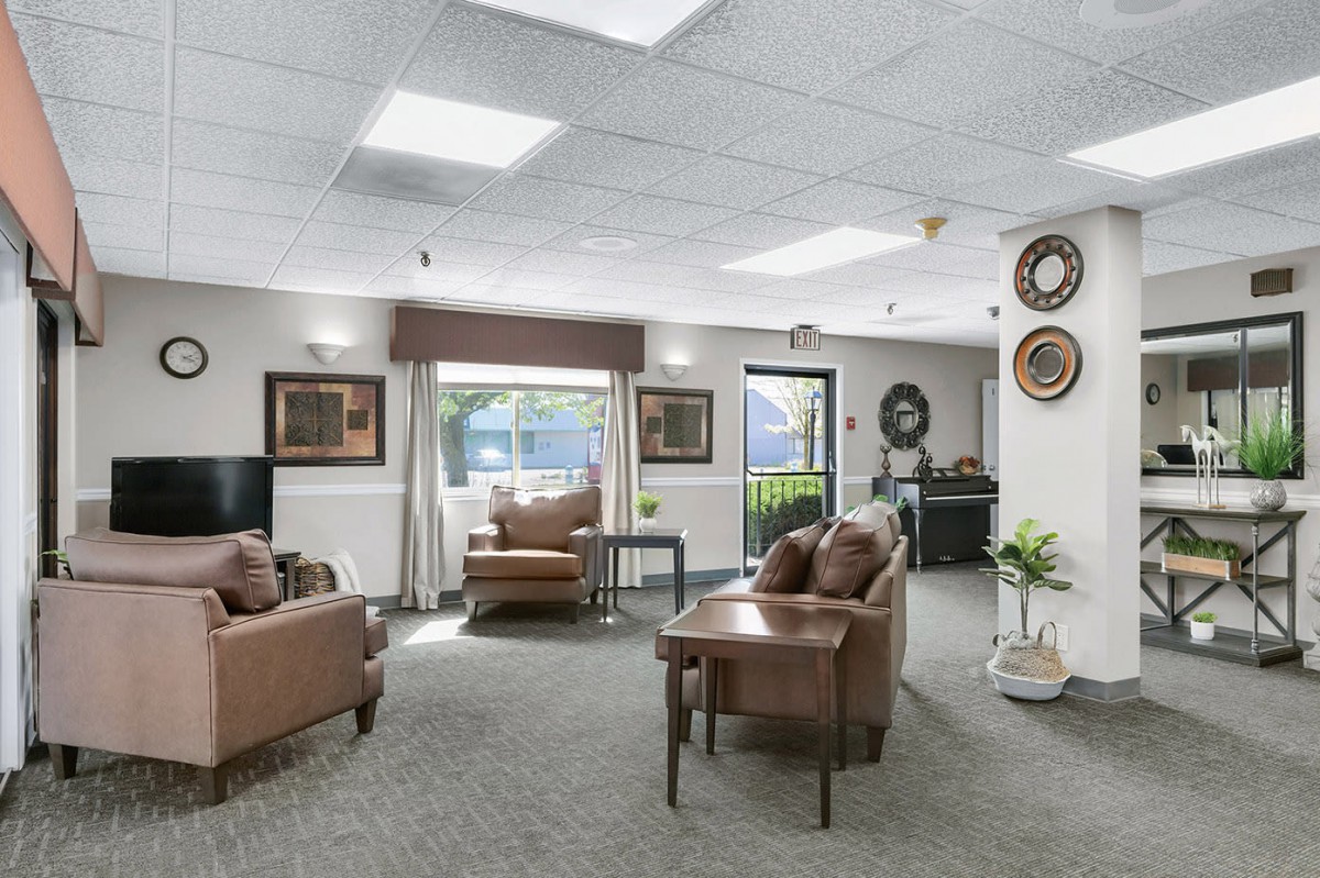 A cozy, well-lit living room with comfortable seating and decorative elements.