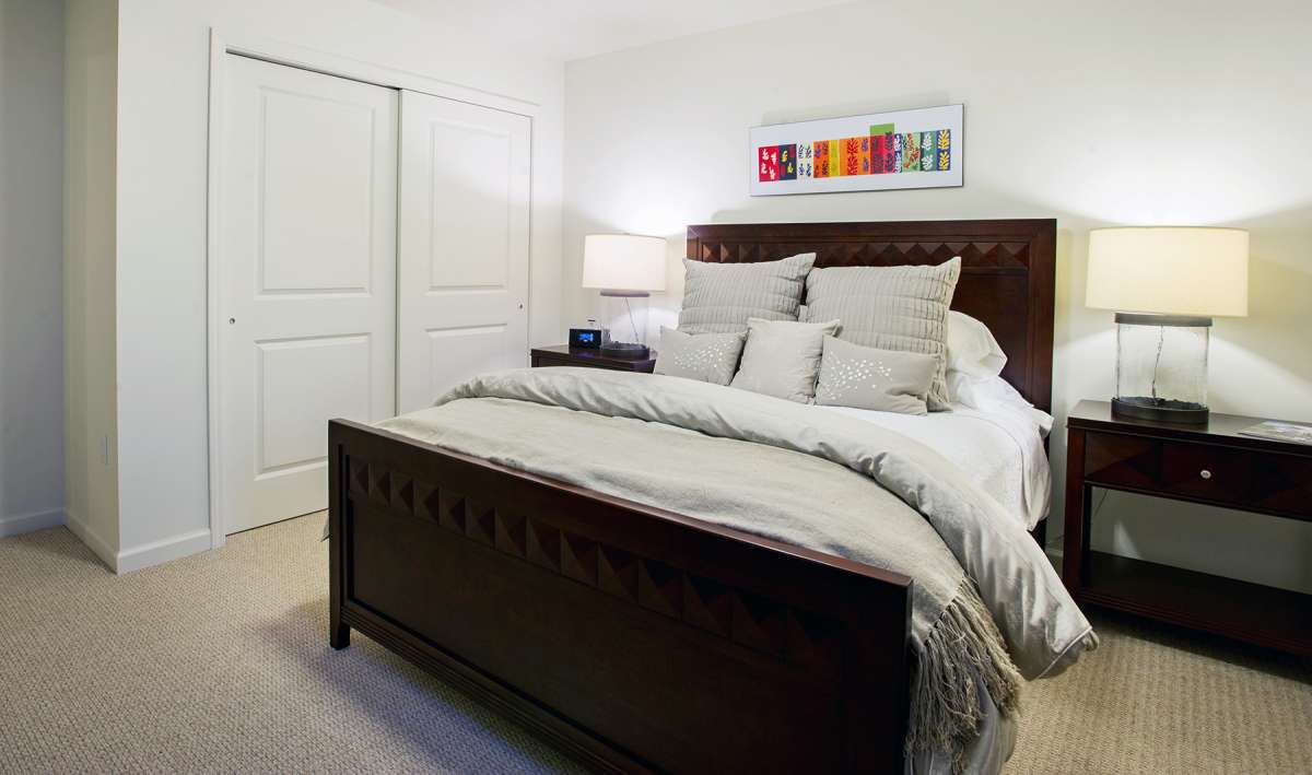 A cozy, well-decorated bedroom with a large bed and modern decor.