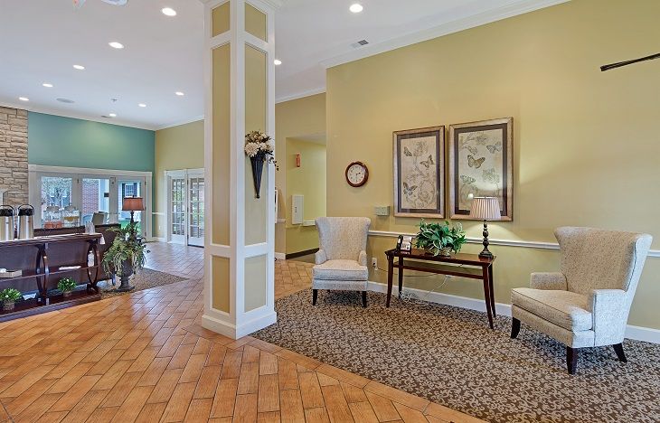 A warmly decorated lobby featuring seating and artwork.