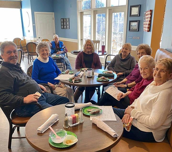 A group of seniors enjoying a social gathering at a cafe.