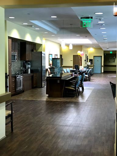 A view of a spacious and modern kitchen-dining area designed for community gatherings.