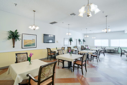 A spacious and well-lit dining area with neatly arranged tables and chairs, perfect for social gatherings.