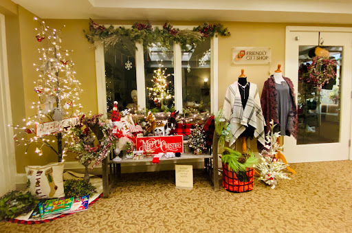 A cozy holiday shopping display featuring festive decorations, clothing, and gift items.