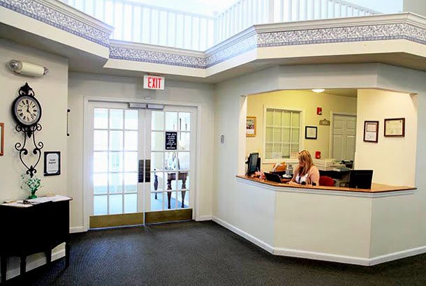 A reception area with a desk and entrance in an office setting.
