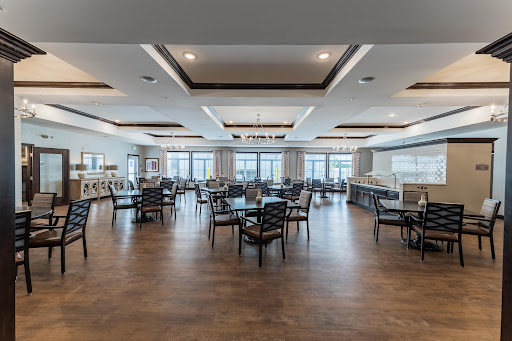 A spacious and modern dining area featuring elegant furniture and large windows that provide ample natural light.