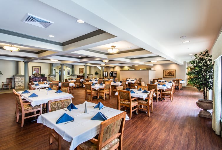 An elegant restaurant dining area with neatly set tables and chairs.