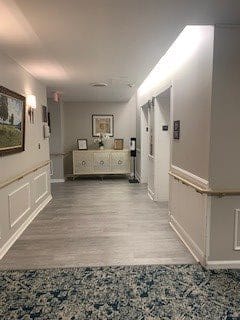 A well-lit hallway with elevators and decorative elements.