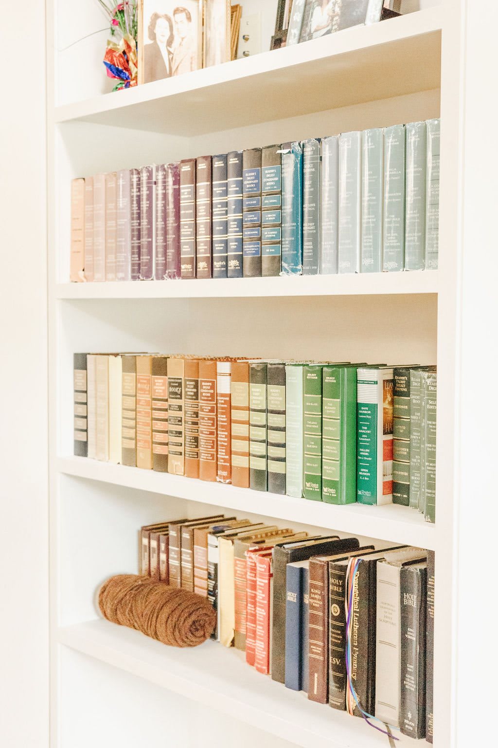 A neatly organized bookshelf displaying a collection of books in various colors and sizes.