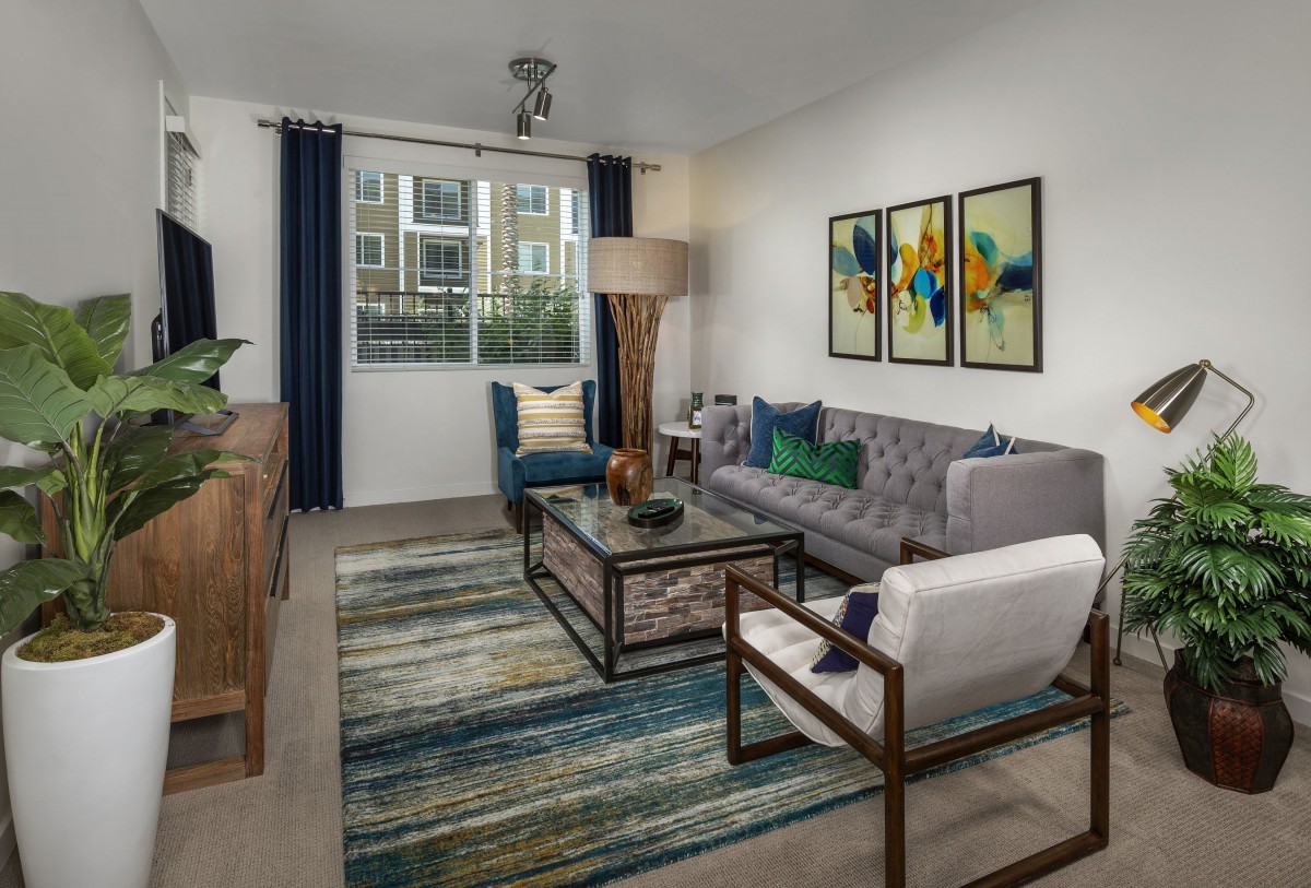 A modern living room with contemporary furniture and vibrant artwork.