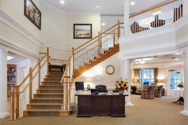 A welcoming office lobby with a reception desk and staircase.