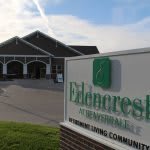 Entrance to a senior living community with visible signage.
