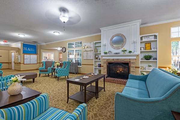A cozy living room with comfortable seating around a fireplace.