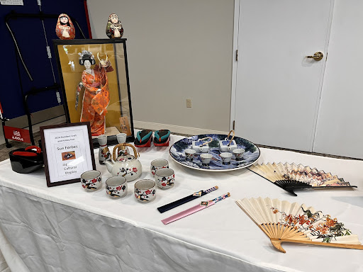 A beautifully arranged display showcasing traditional Japanese crafts, featuring ceramics and artwork.