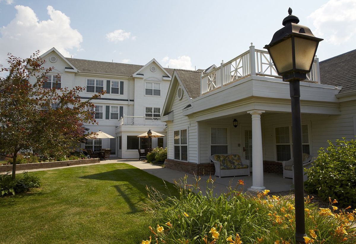 A residential building with a well-maintained garden and outdoor seating area.
