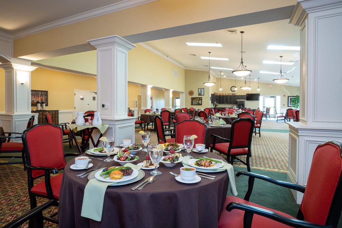 An elegantly set dining room with neatly arranged tables and chairs.