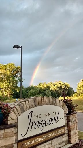 A beautiful rainbow arcs over a lush landscape, bringing a touch of color to the scene.