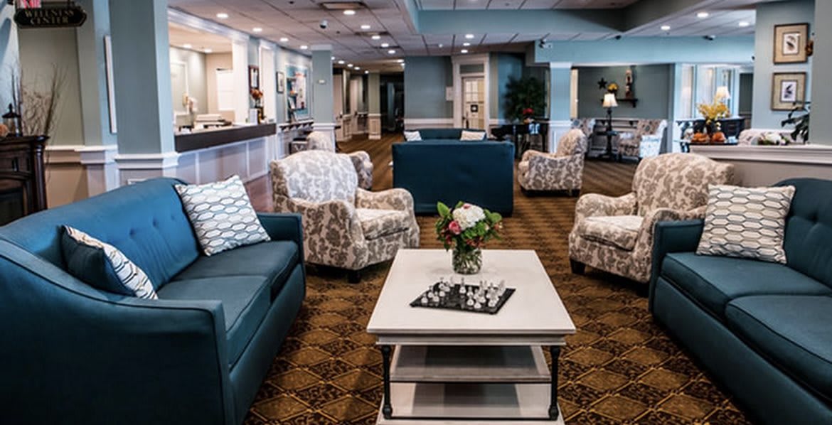 A modern and inviting lobby seating area with comfortable chairs and a coffee table.