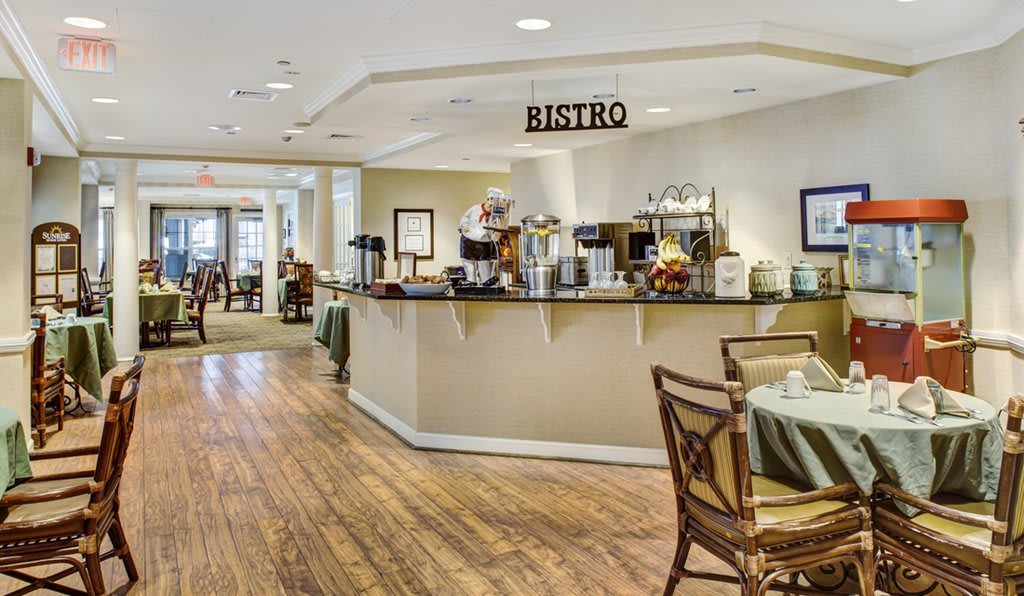 A cozy bistro interior with a coffee counter and comfortable seating.