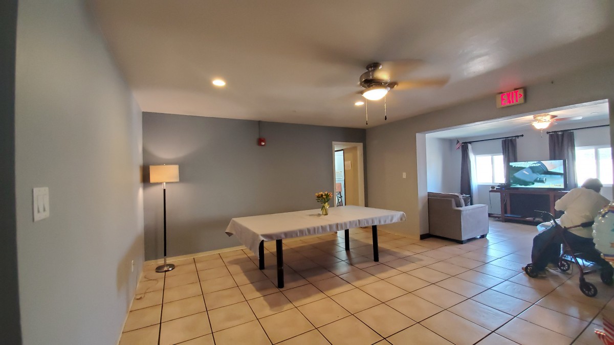 A spacious living room with a dining table, sofa, and modern decor.