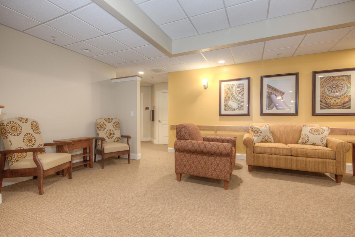 A cozy living room with comfortable seating and decorative artwork on the walls.