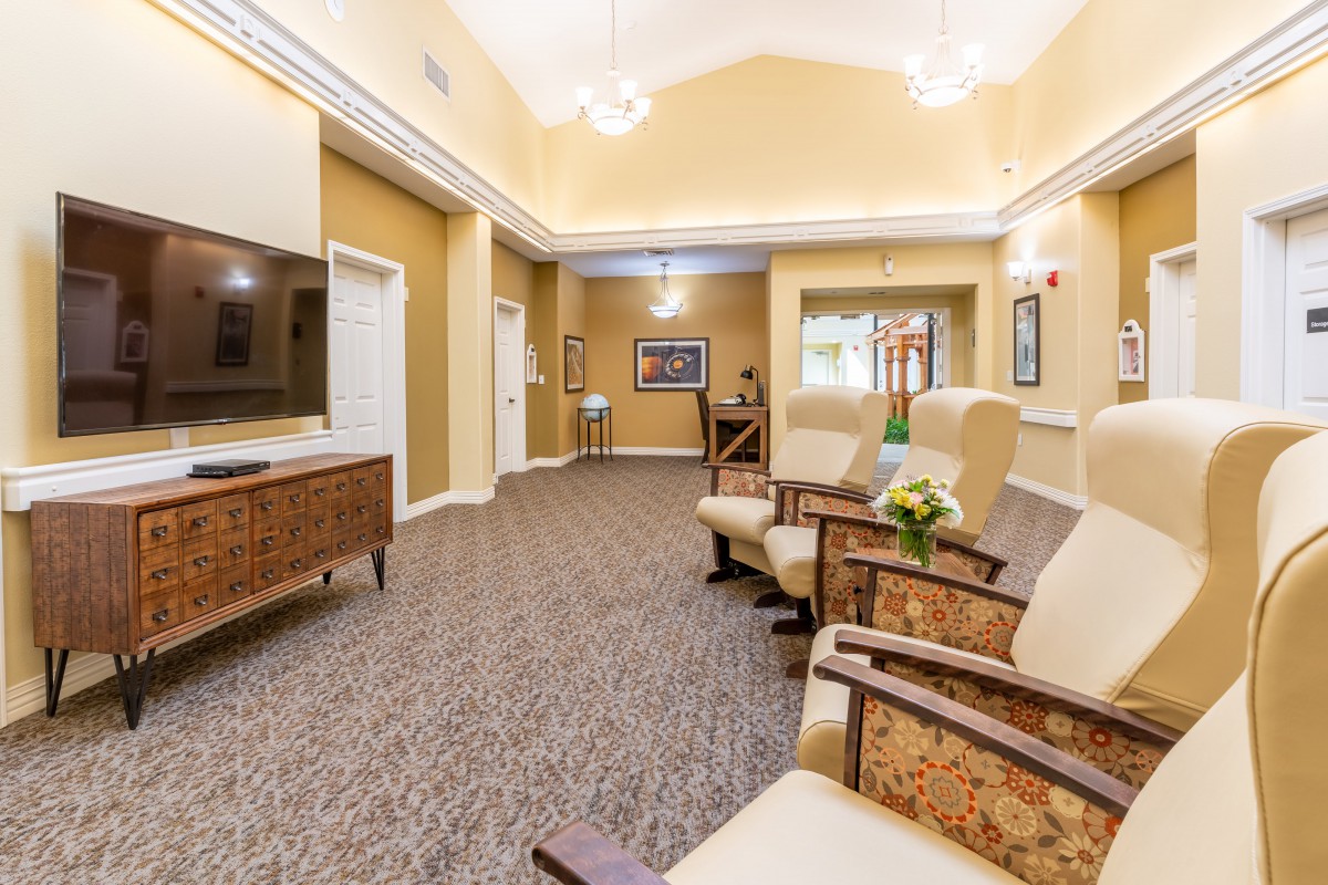 A cozy lounge area with comfortable seating and a television.